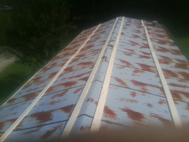 Rusted metal roof panels with new wood purlins before replacement — Storm Damage Roof Repair in Morrisdale by Roofing Brothers