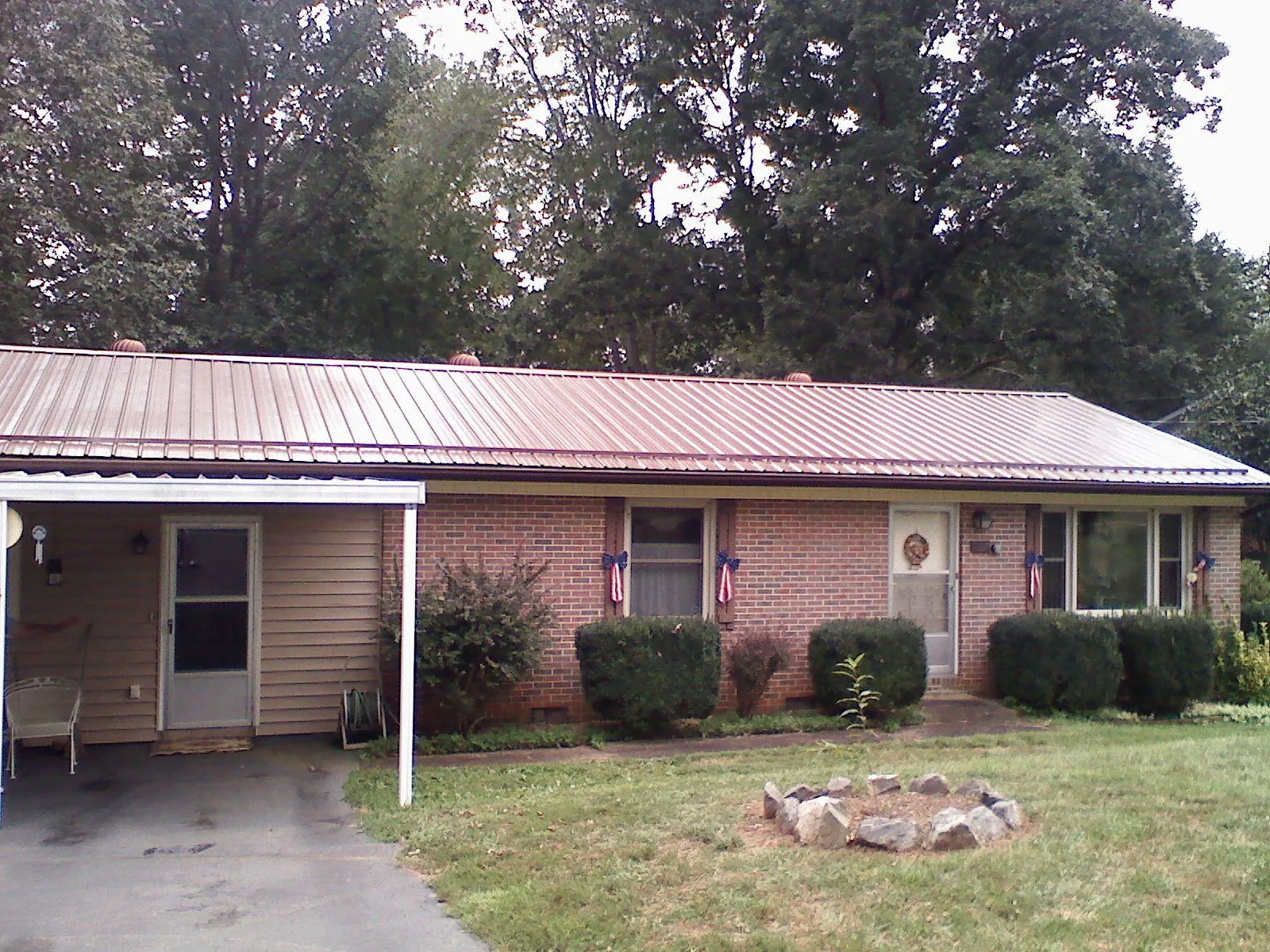 Bronze metal roof and carport on a brick ranch home — Roof Repair work by our crew in Morrisdale